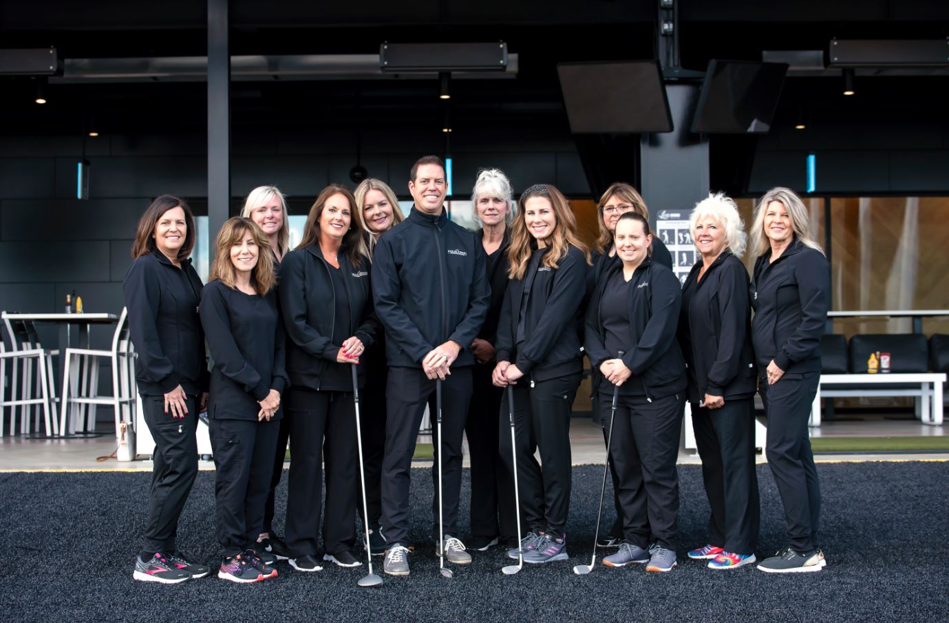 Friendly orthodontic team smiling together during New Year's celebration. Meet our experienced specialists and learn about patient referral programs.