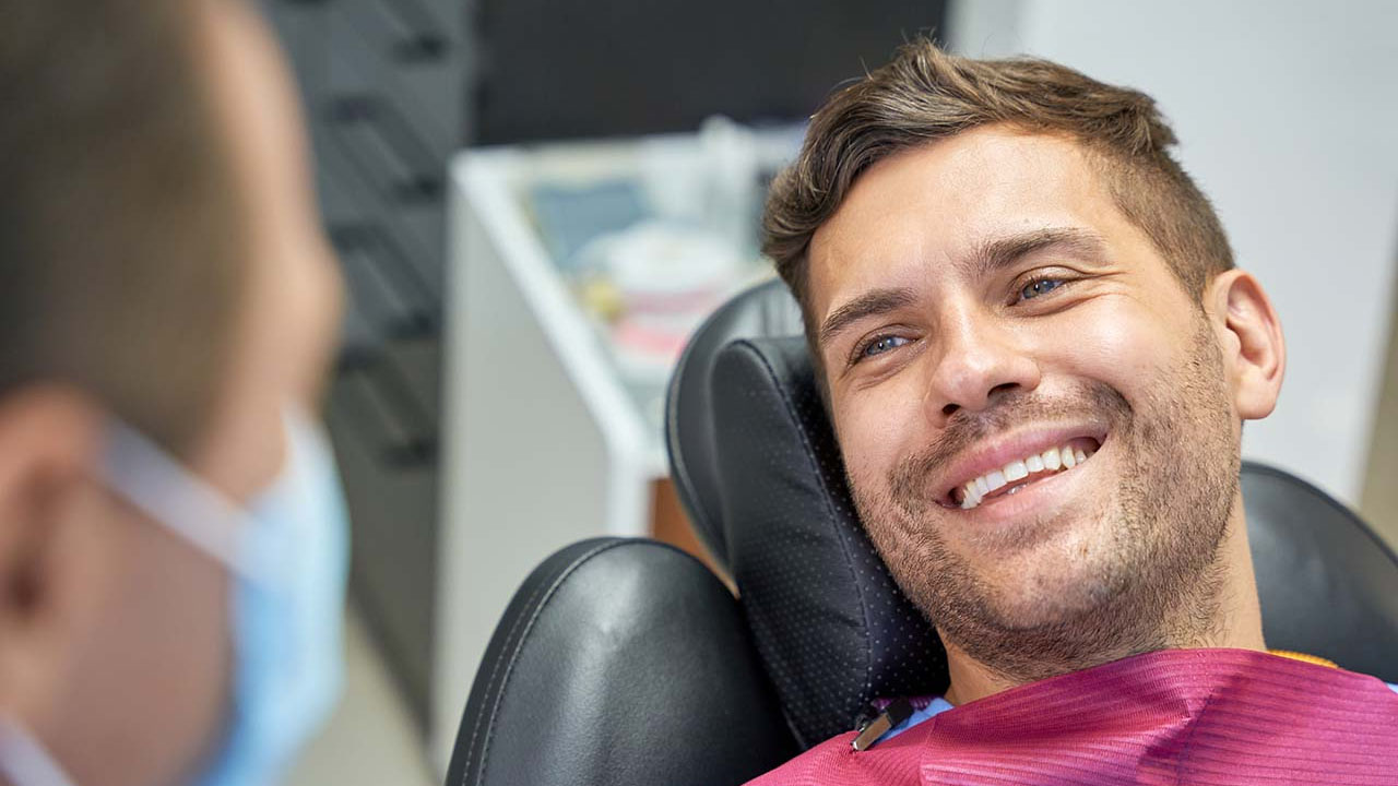 Happy patient receiving orthodontic treatment from their doctor.