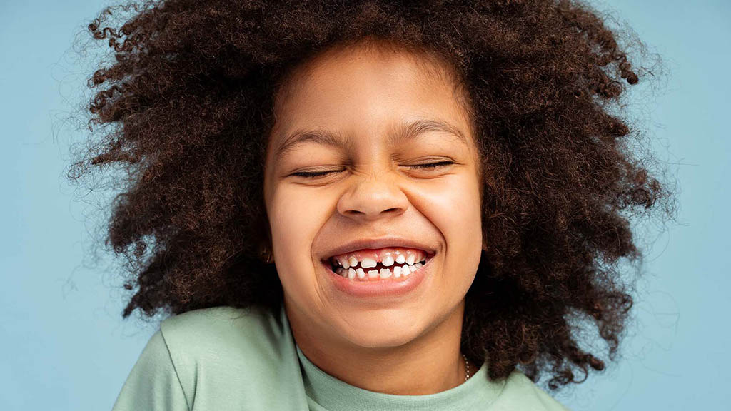 Smiling young child receiving orthodontic treatment. Phase 1 and 2 dental care for kids.